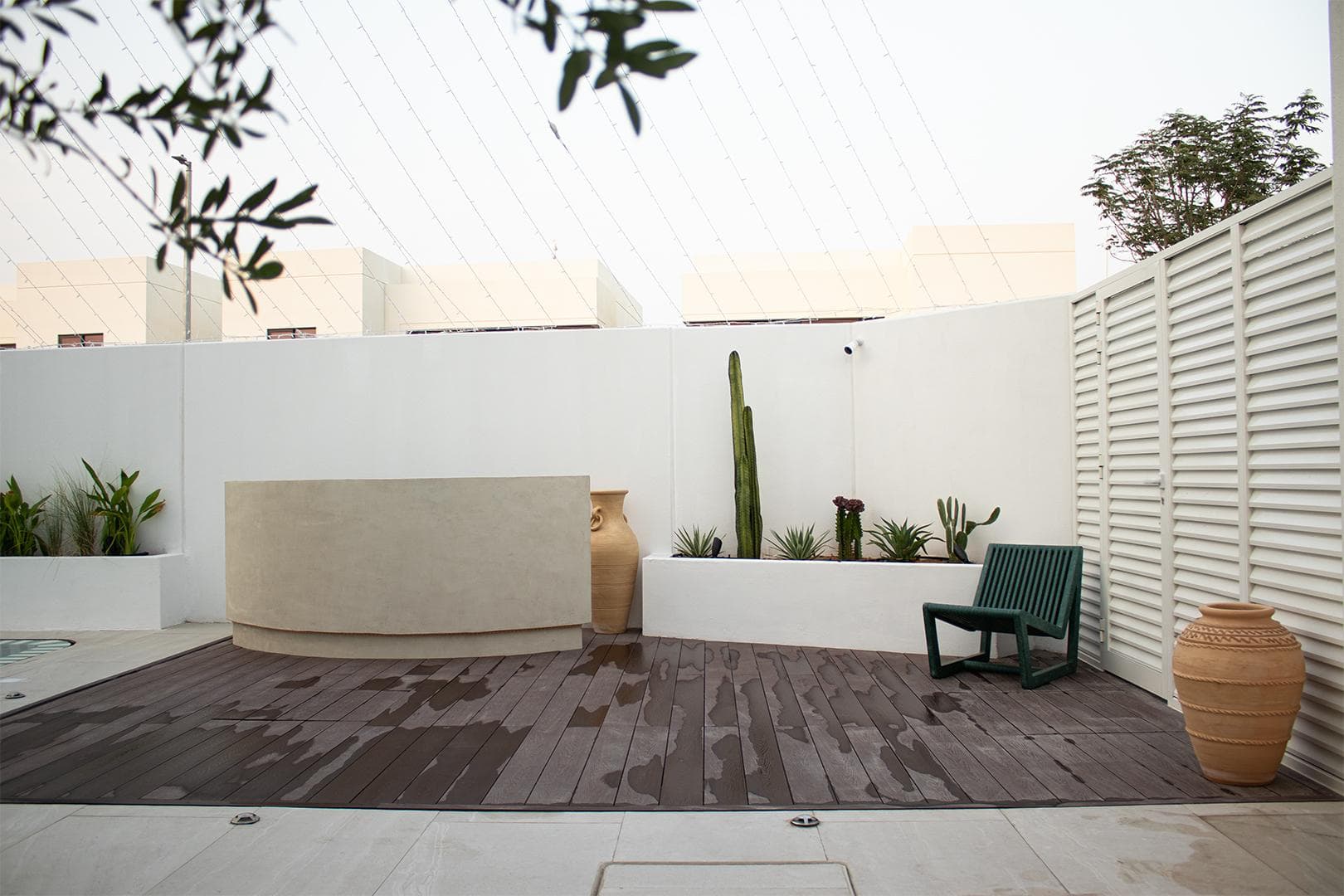 Composite decking terrace with sculpted planters and desert cacti